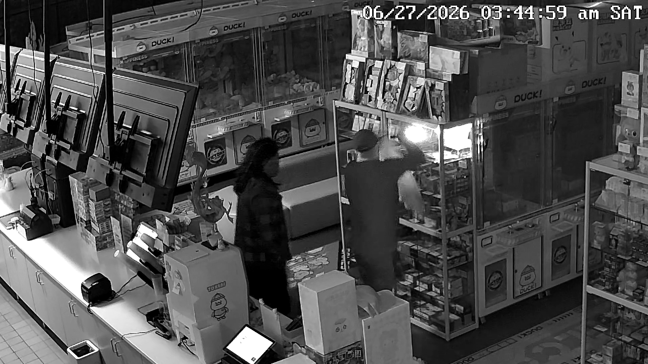 Police investigate a broken storefront window at DUCK! in Eagan after a Pokémon card theft.