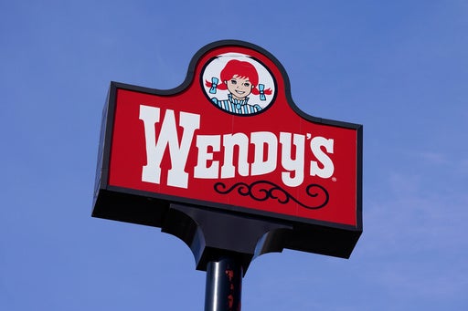 Wendy's restaurant exterior with iconic red logo, symbolizing a potential corporate buyout and future changes.